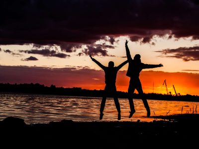 young happy couple jumping on beach. jump